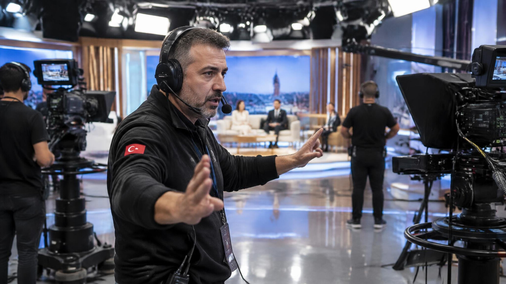 Broadcast crew member coordinating during a live TV recording